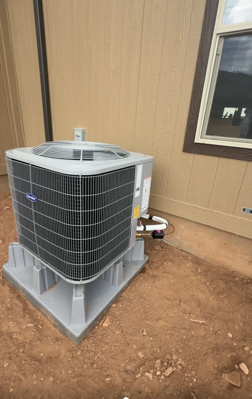 New Carrier residential AC condenser install by Honest Heating & Cooling in a Utah home